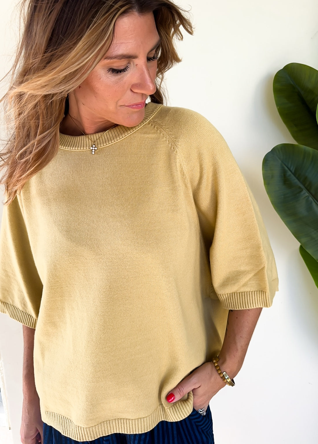 Close-up of the Sunlit Stroll Dolman Sweater showing knit texture and ribbed sleeve trim.