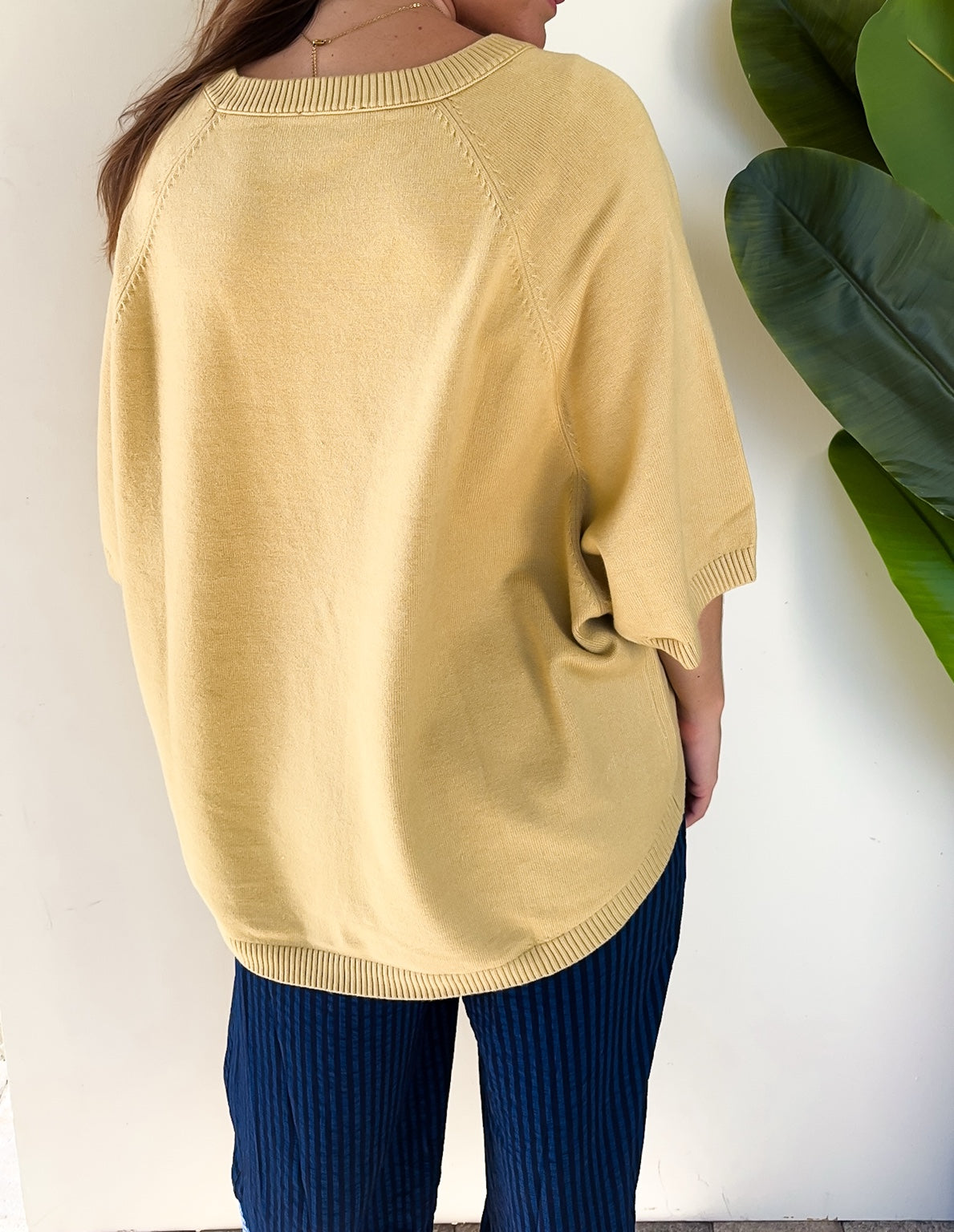 Back view of the Sunlit Stroll Dolman Sweater showing its relaxed fit and ribbed hem.