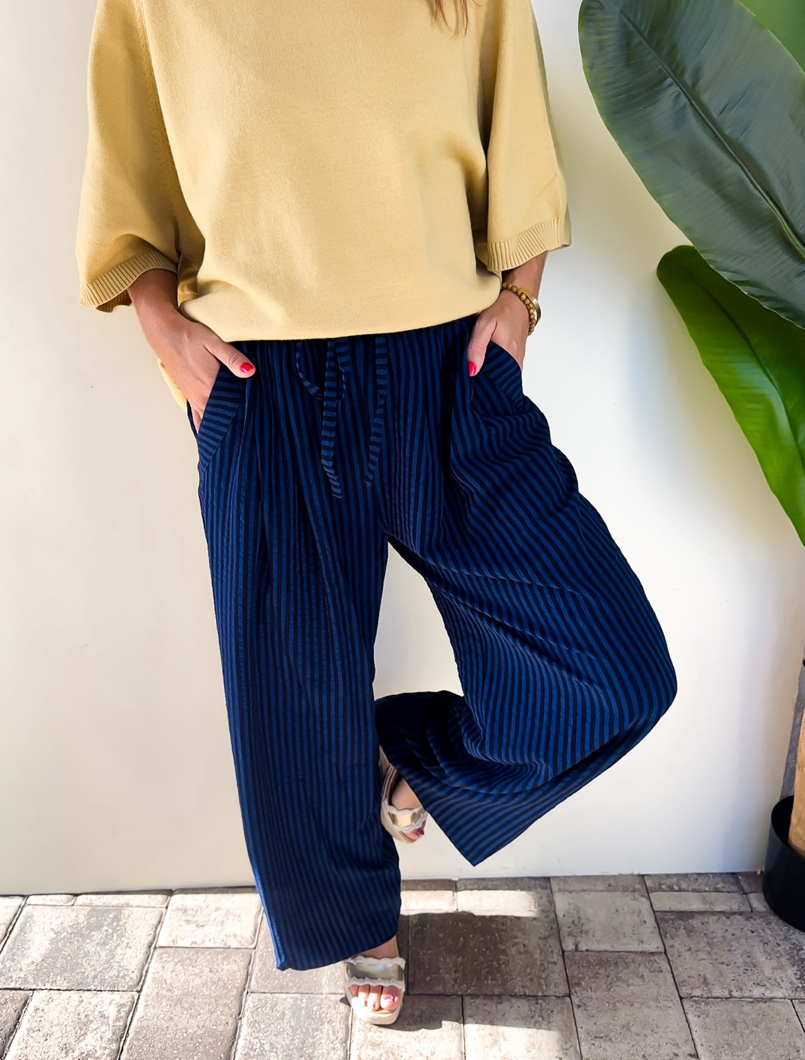 Front detail of the After Hours Stripe Pants showing the drawstring waistband, pockets, and wide legs.