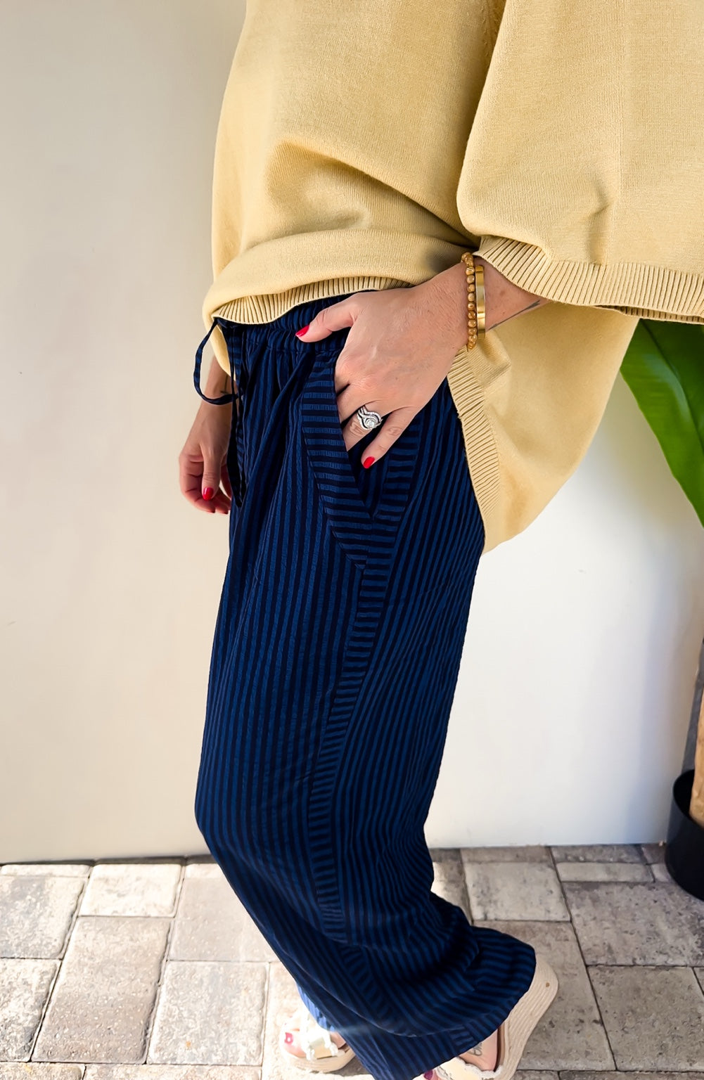 Side close-up of the After Hours Stripe Pants showing the elastic waist, drawstring, pocket, and midnight blue stripes.