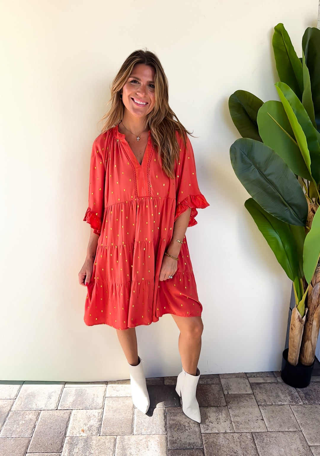 Front outfit view of the terracotta Copper Confetti Dress styled with white boots.